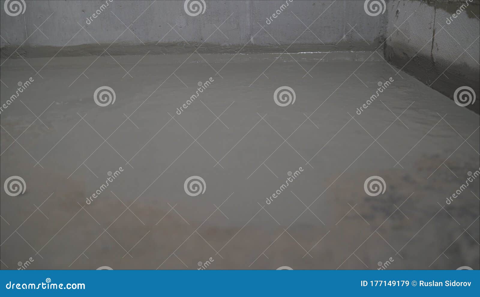 A Worker is Waterproofing a Concrete Floor. Construction Mix