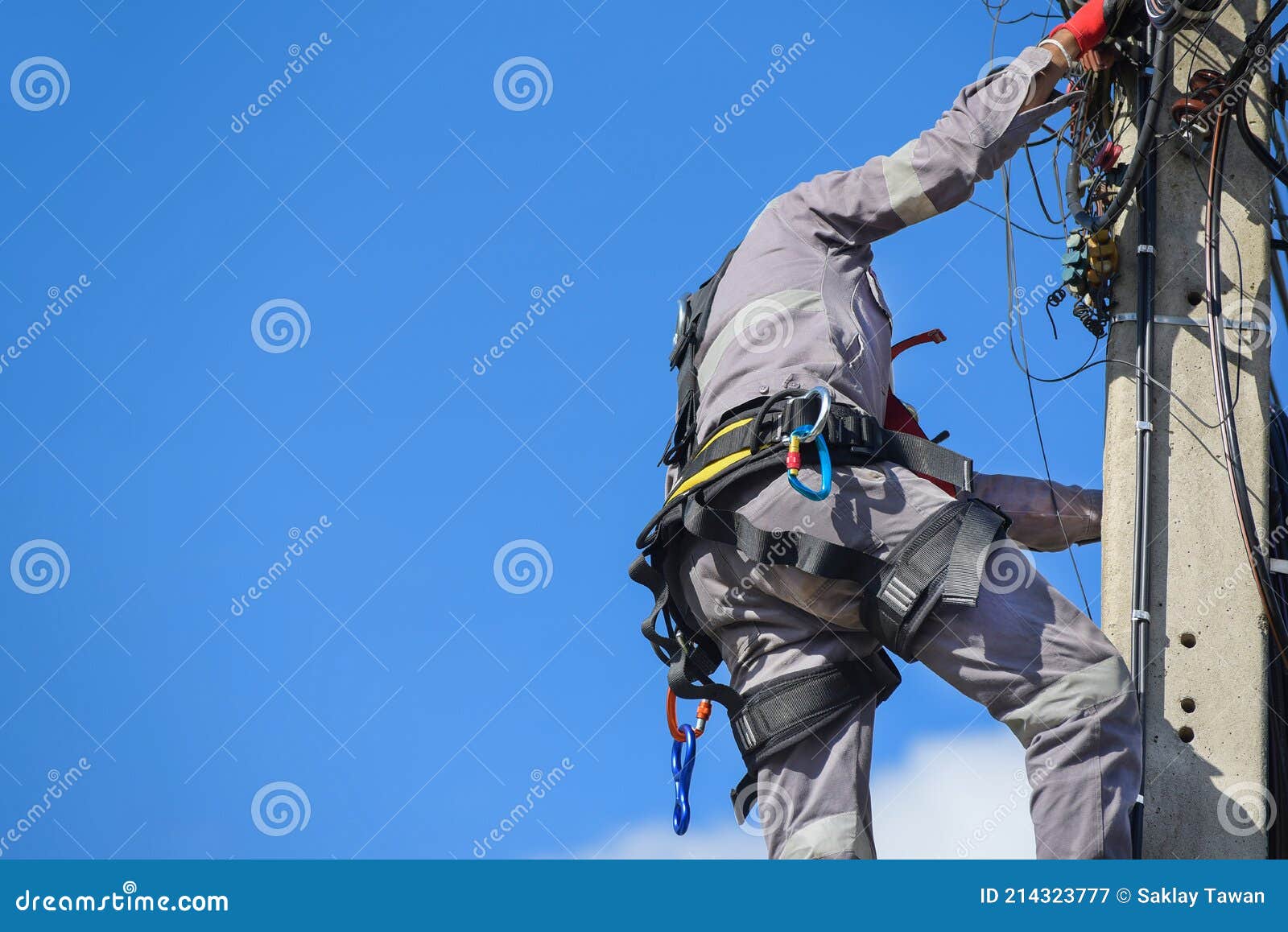 A Worker Wearing Seat Belts Climbed an Electric Pole To Fix Old Wires.  Stock Image - Image of horizontal, examining: 214323777
