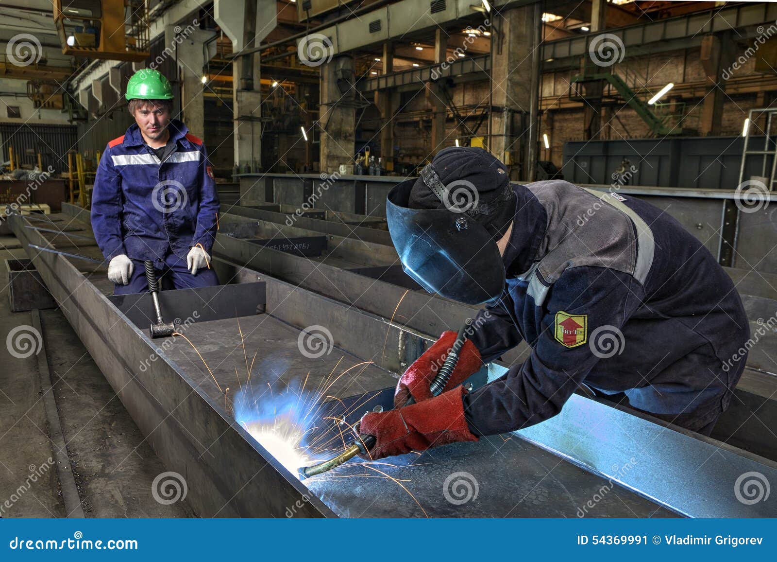 Worker Welder Manually Weld Steel Sheets Using Gas Torch, MIG