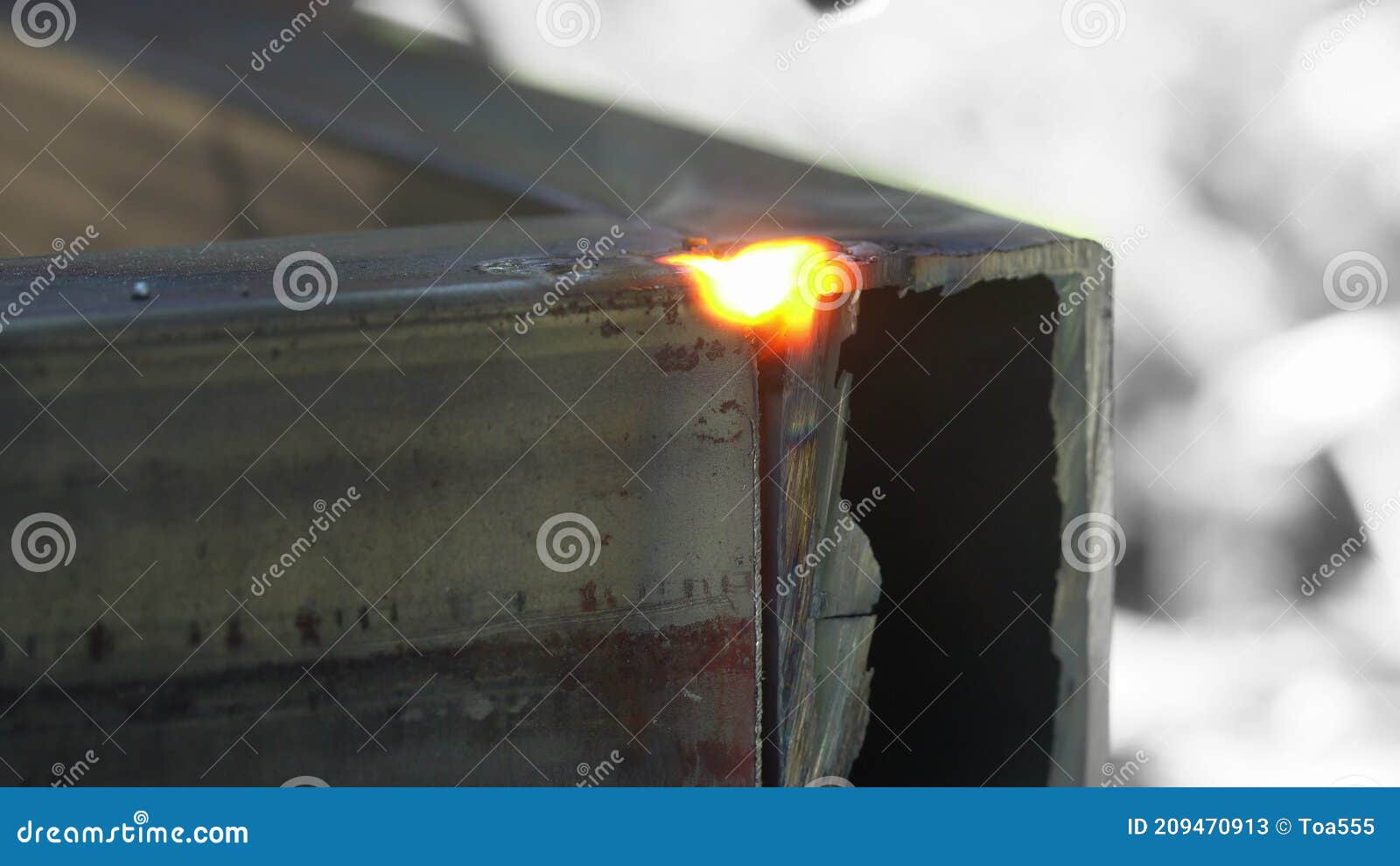 Worker Welding Two Pieces of Rectangular Tubing Together for Structure