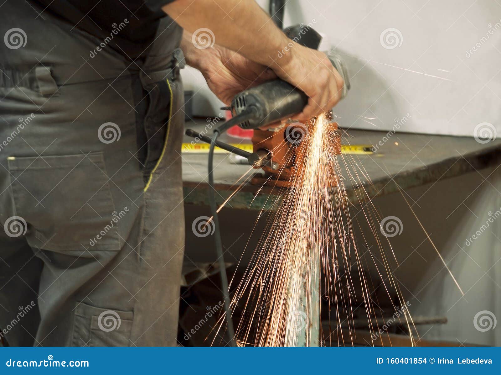 Worker in a Grinder Processes Metal, from Which Hot Bright
