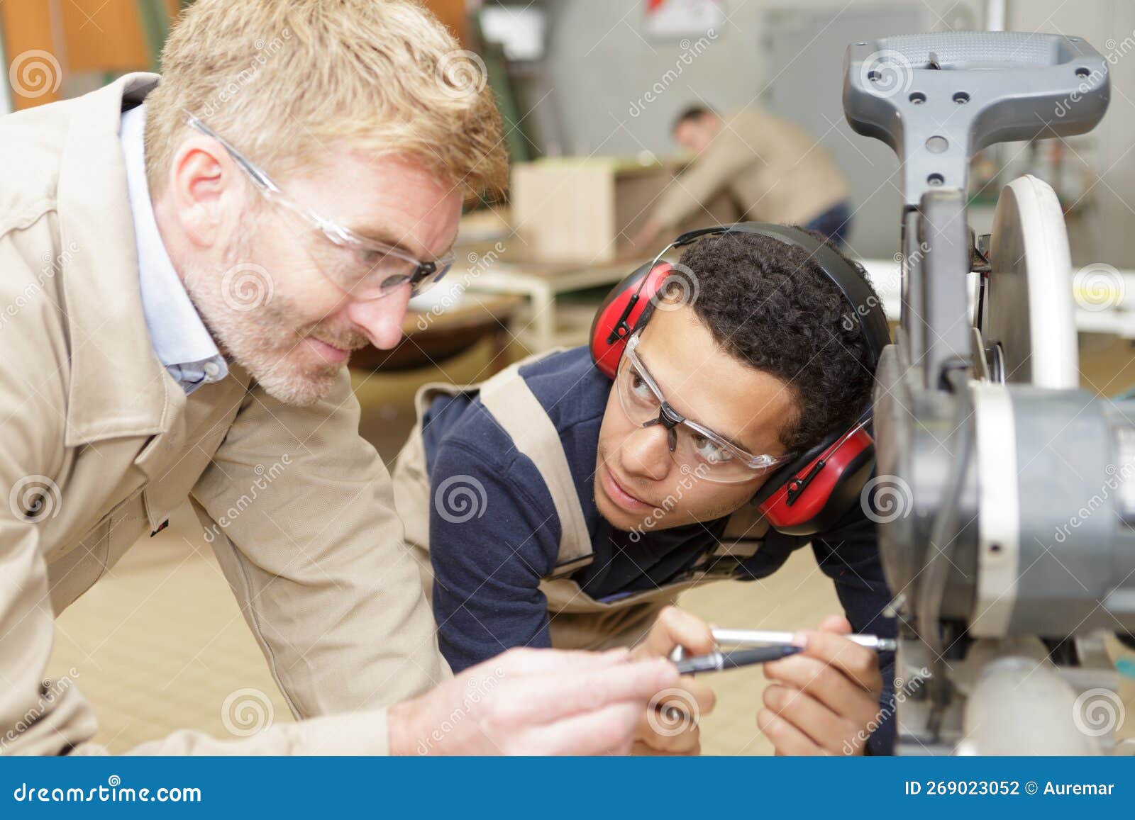 Workers and Apprentice Wearing Earmuffs Stock Photo Image of careful