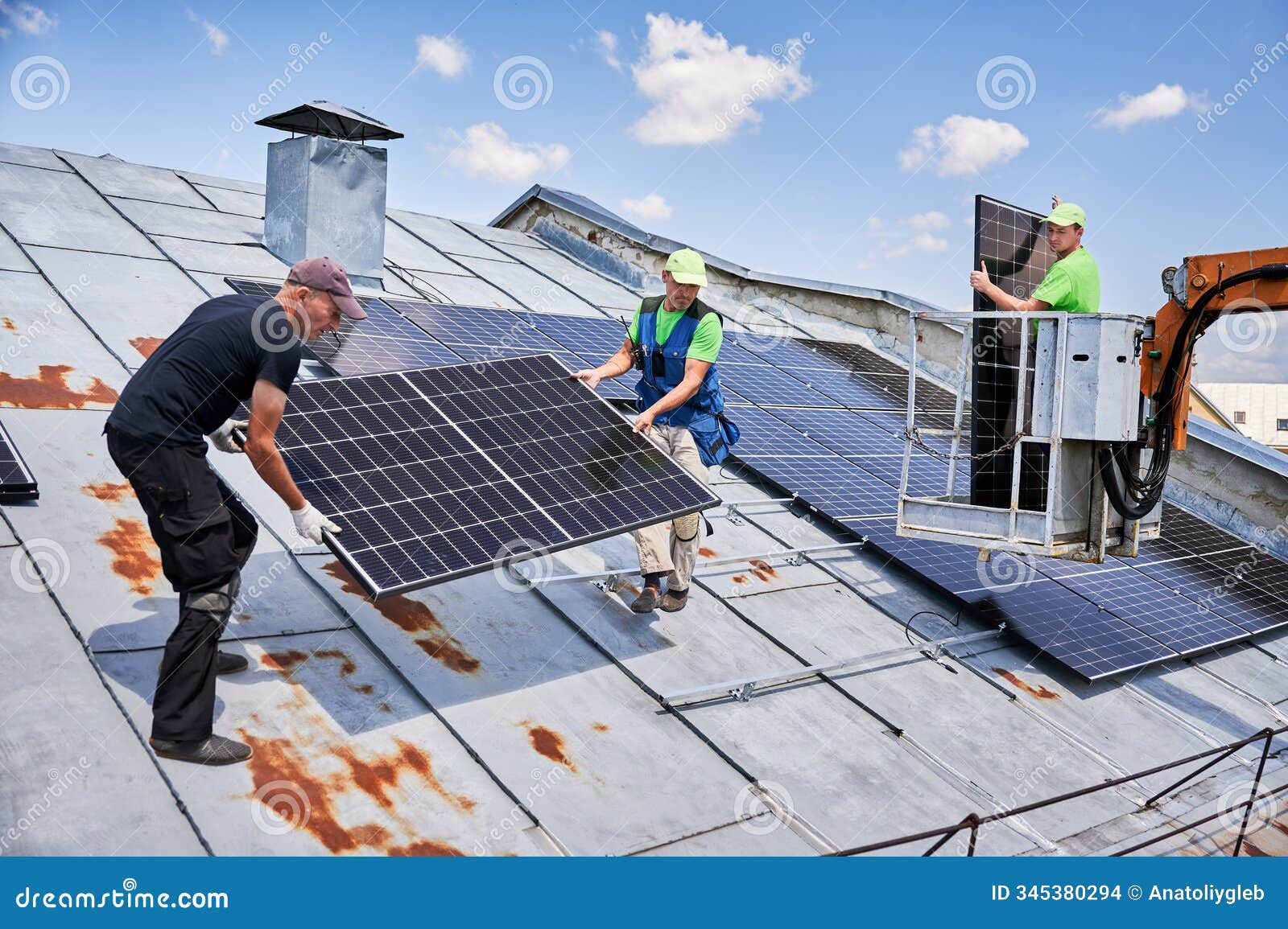 workers building solar panel system on roof of house. installers carrying photovoltaic solar module