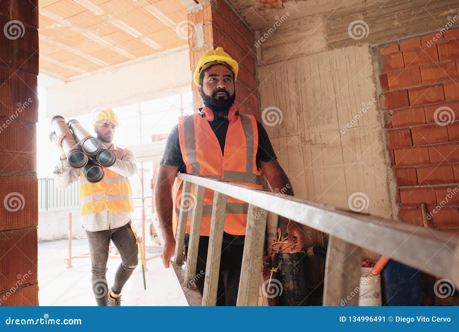 workers in construction site using tools and heavy equipment
