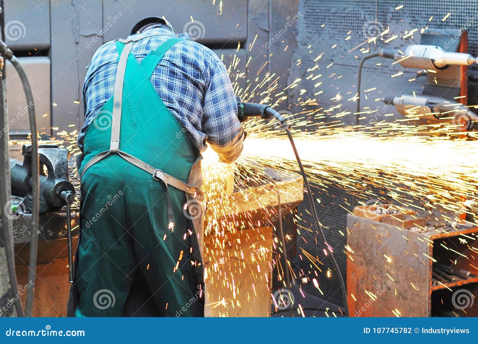 Workers In A Foundry Grind Castings With A Grinding Machine He Stock
