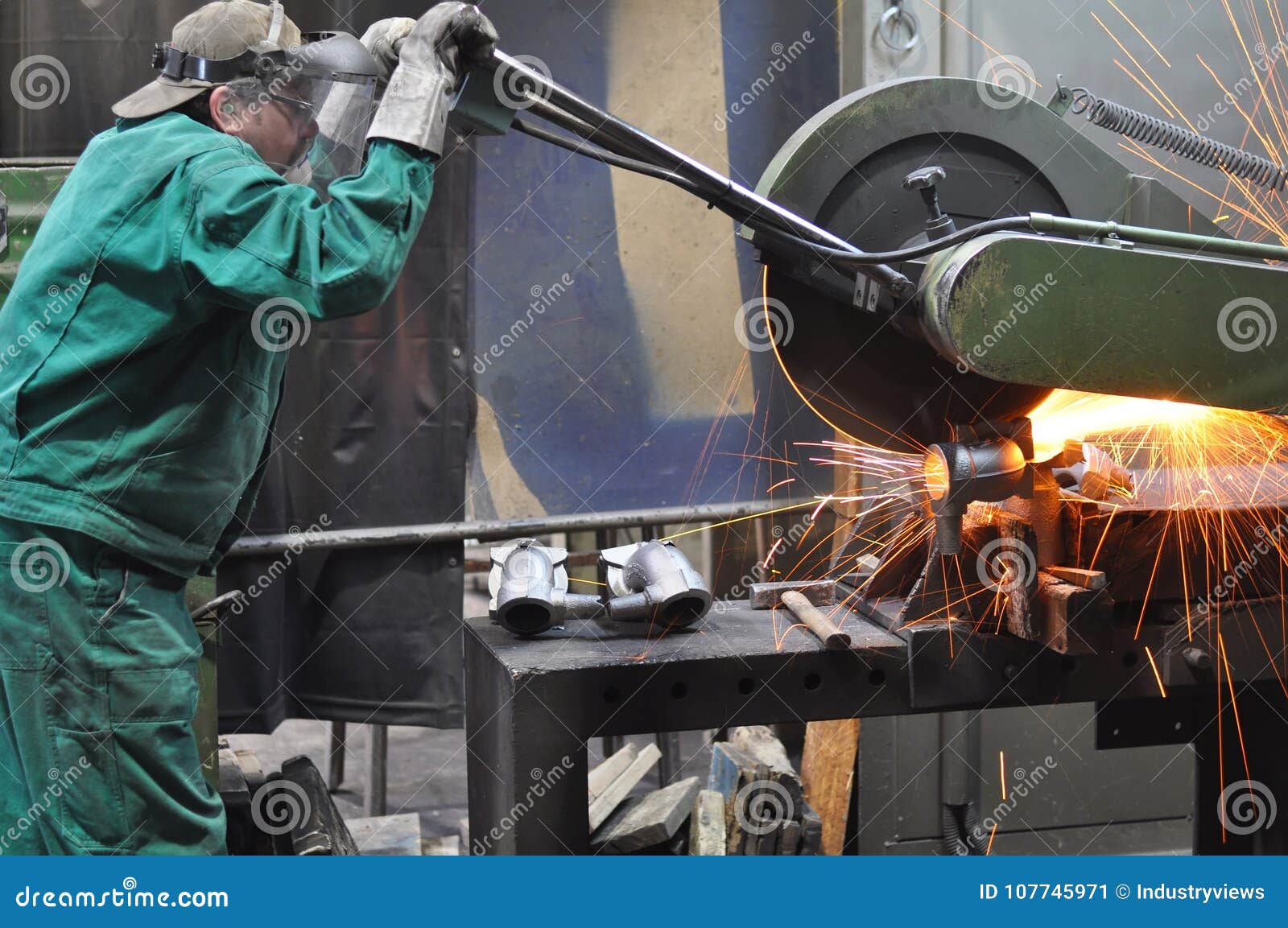 Workers In A Foundry Grind Castings With A Grinding Machine He Stock