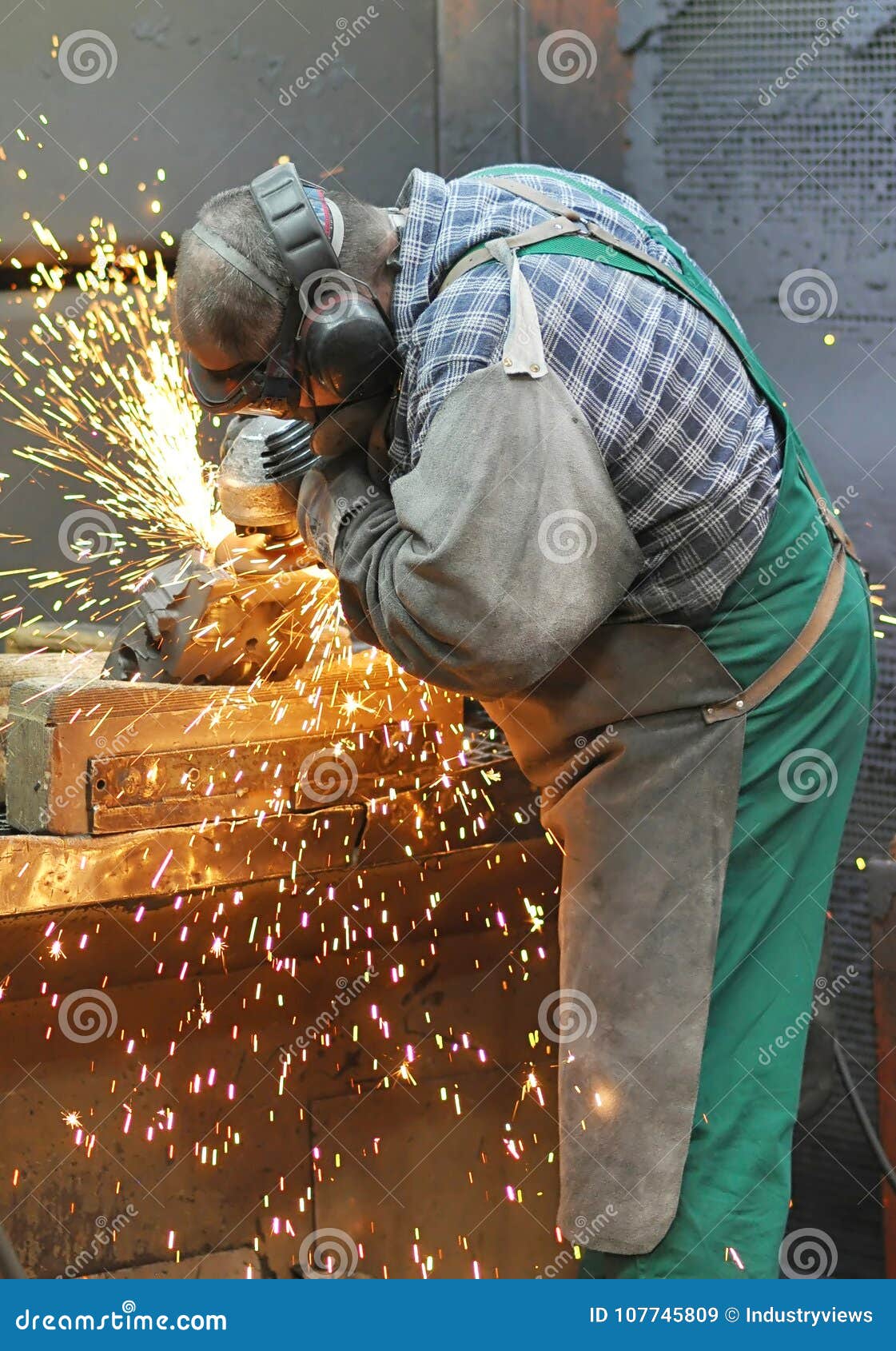 Workers In A Foundry Grind Castings With A Grinding Machine He Stock