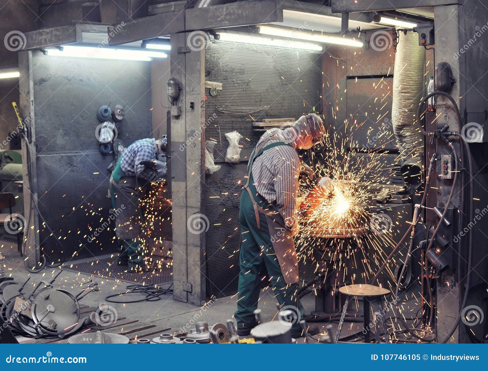 Workers In A Foundry Grind Castings With A Grinding Machine He Stock