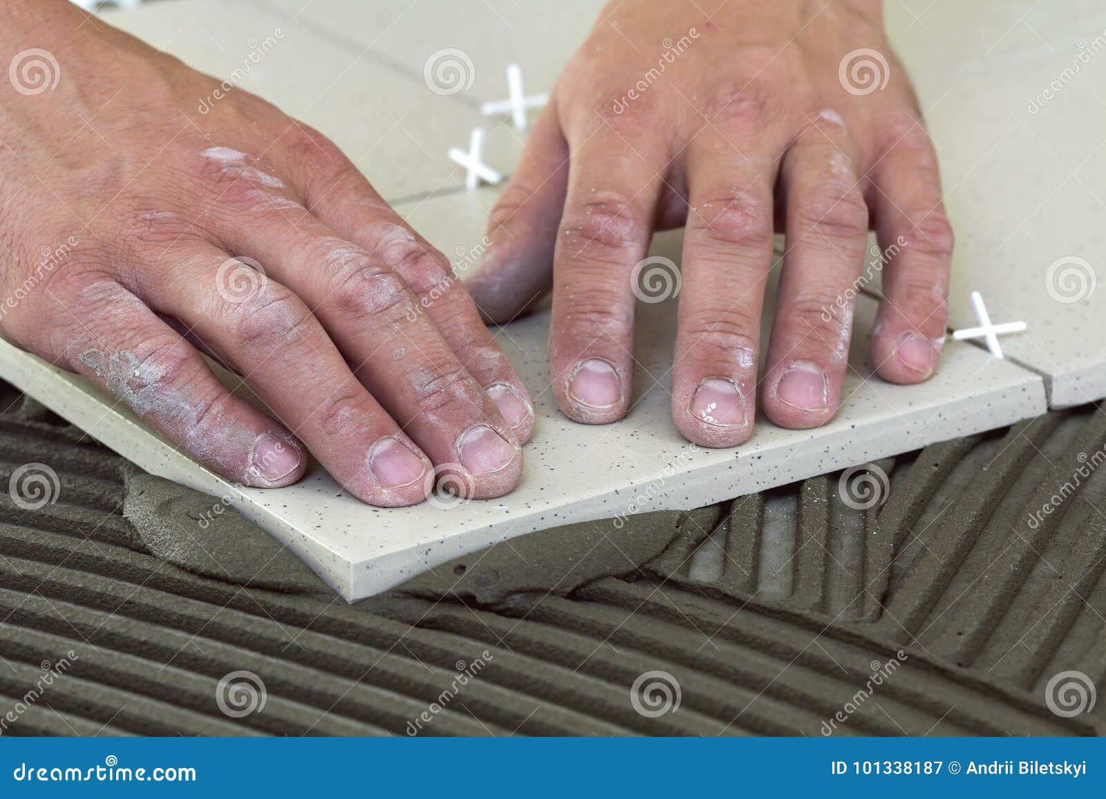 Workers Hands with Ceramic Tiles and Tools for Tiler. Floor Tile Stock