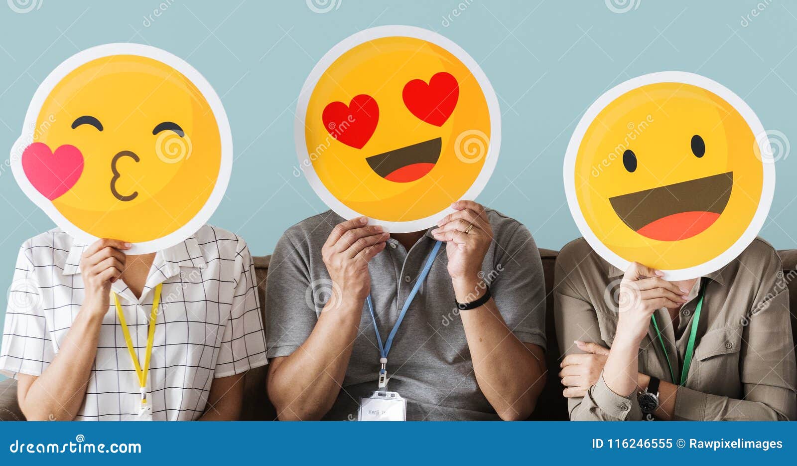 workers holding happy face emojis
