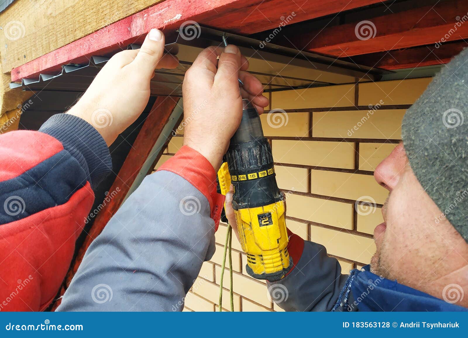 Workers Install Eaves Under the Roof of the House Stock Photo Image