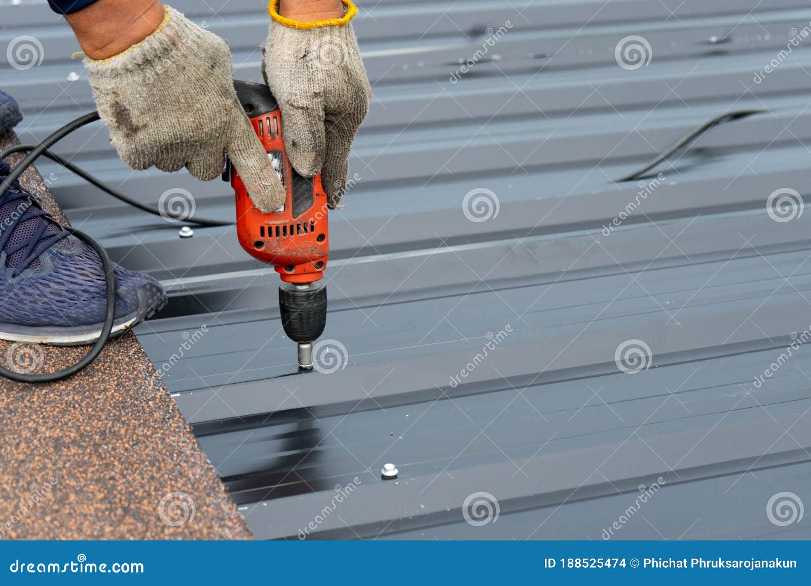 Workers Installing the Metal Sheet Roof by Electrical Drilling Machine