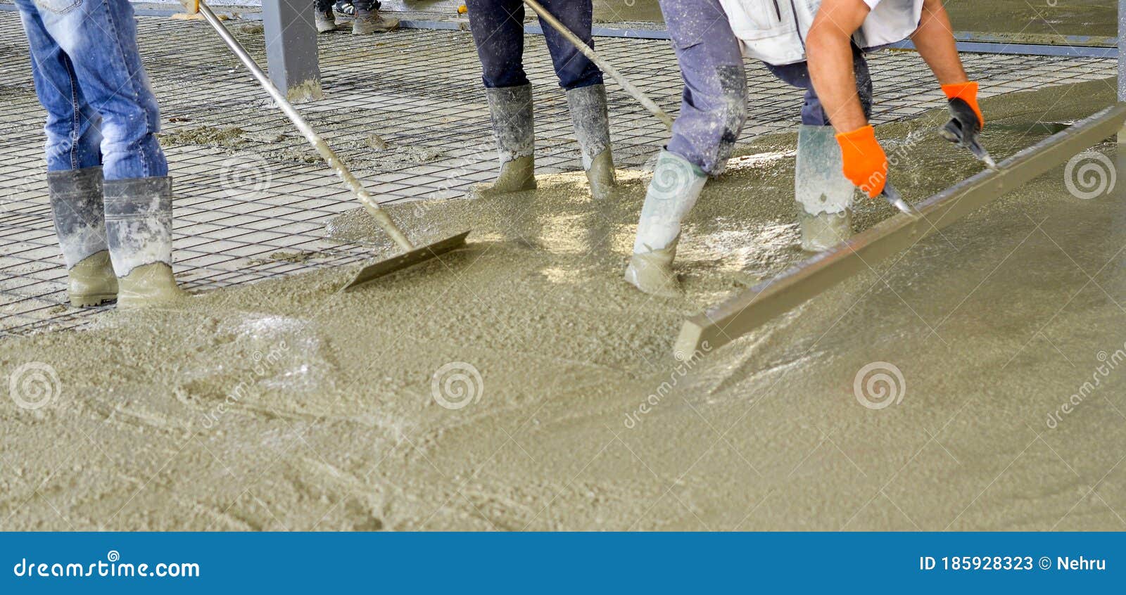 Leveling Concrete With Trowels, Laborer Spreading Poured Concrete