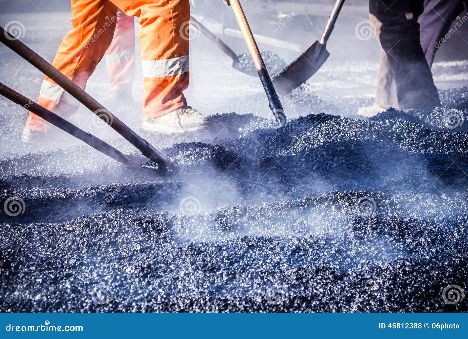 workers making asphalt with shovels