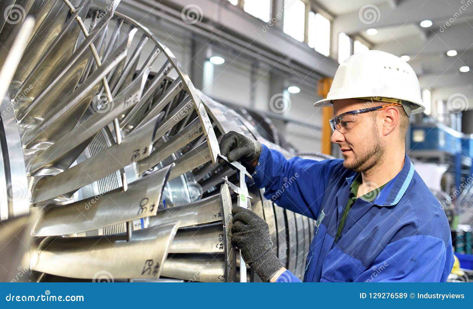 workers manufacturing steam turbines in an industrial factory