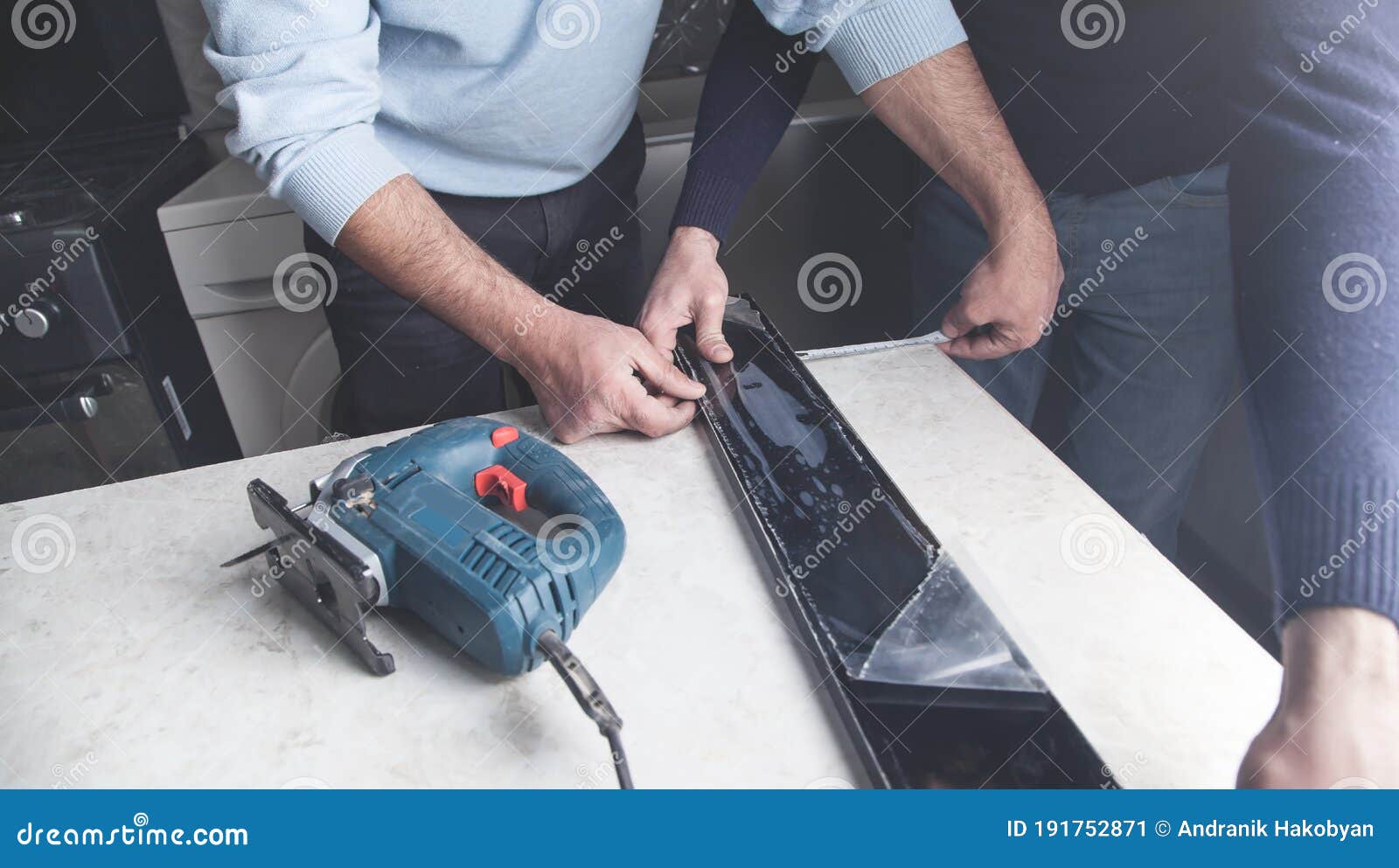 Workers Measuring and Cutting Kitchen Countertop Using Electric Saw