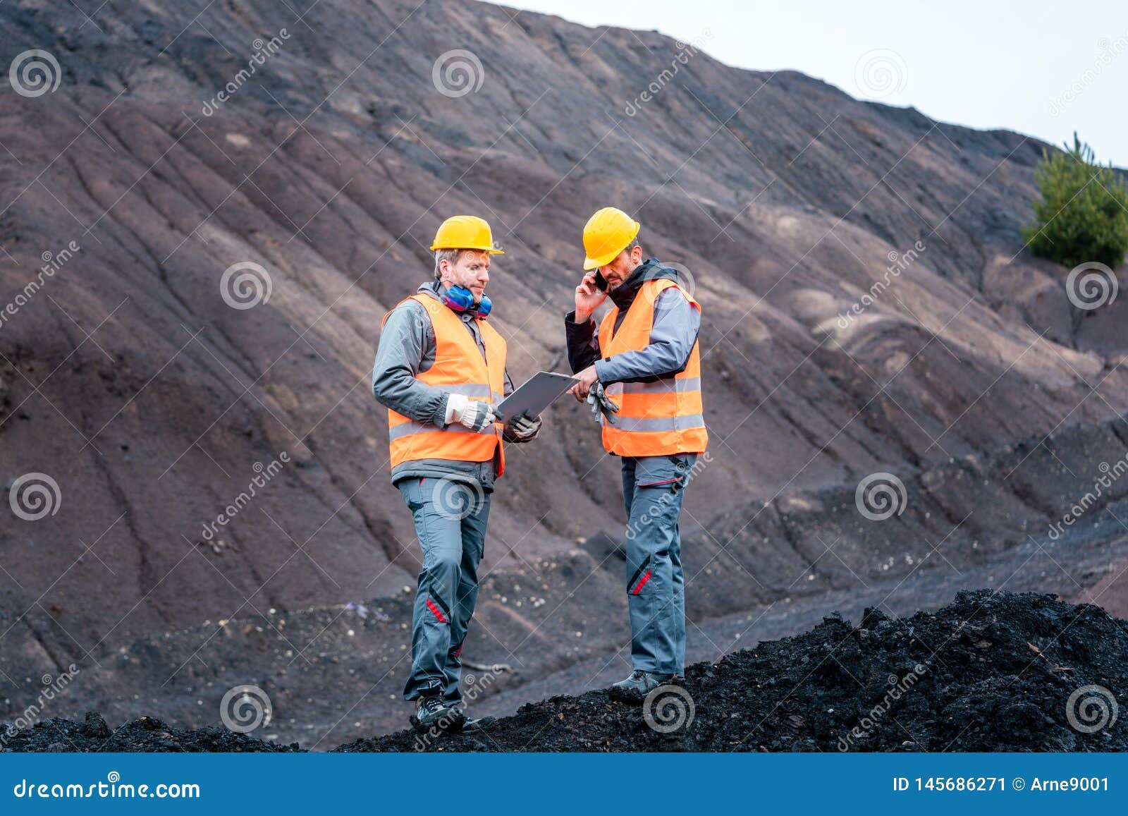 workers in open-cast mining operation pit