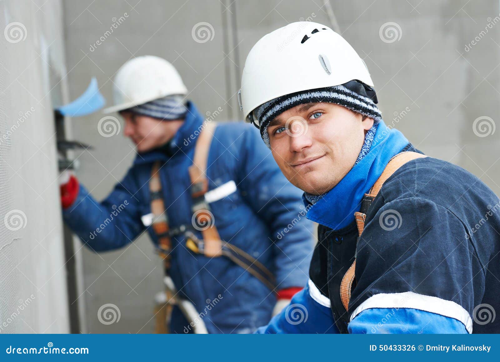 workers at plastering facade work