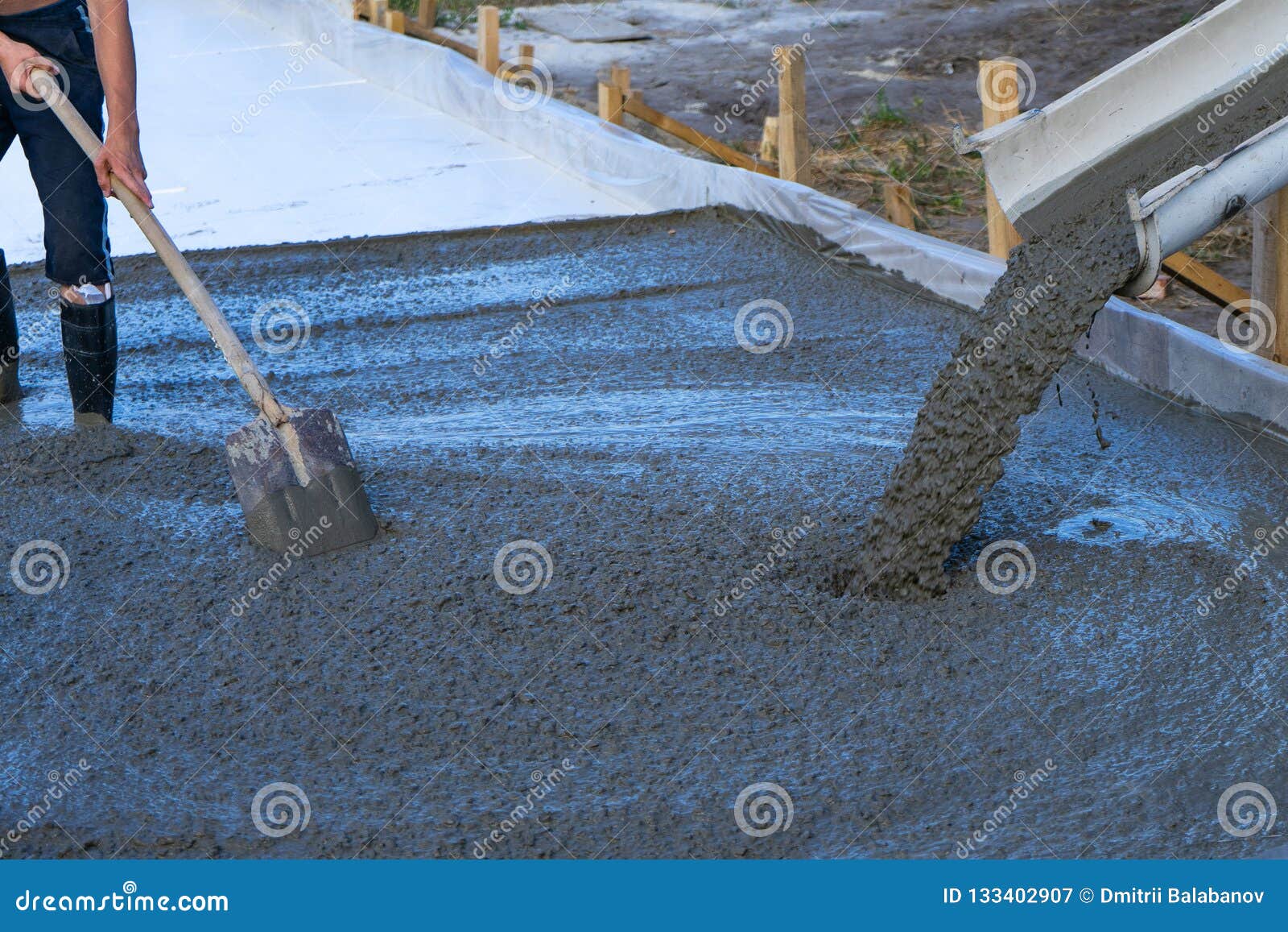 workers pour the foundation for the construction of a residential building using mobile concrete mixers