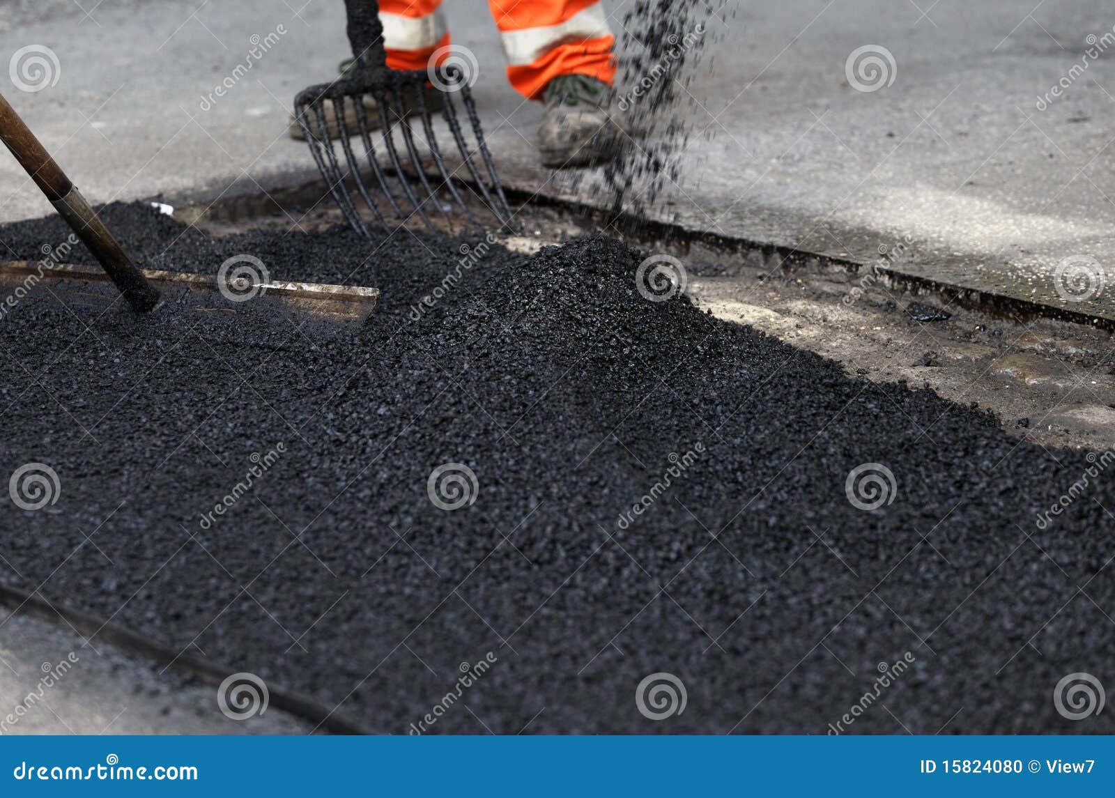 workers smoothing asphalt