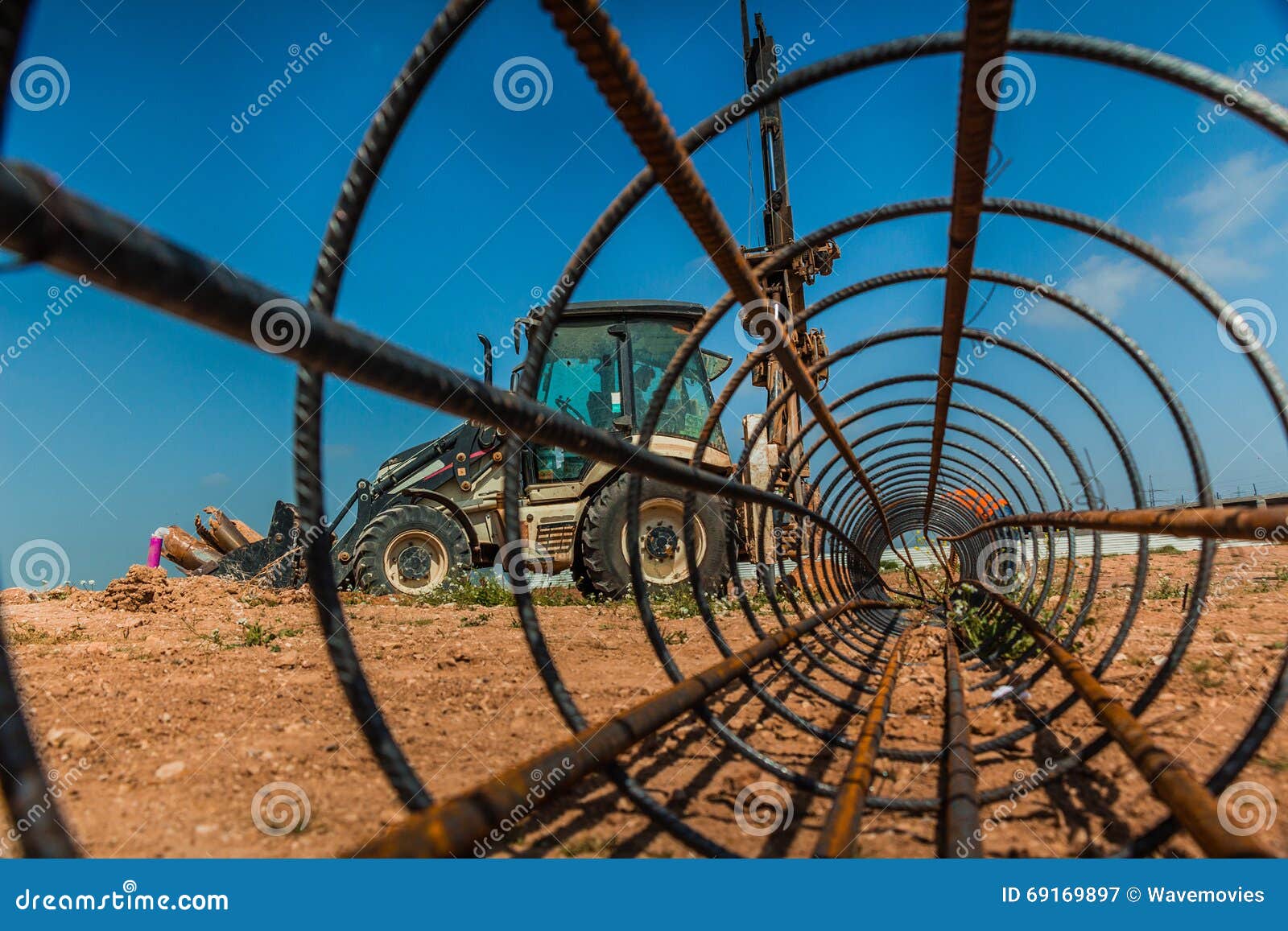 Workers and a Tractor with a Drilling Device at a Construction S Stock