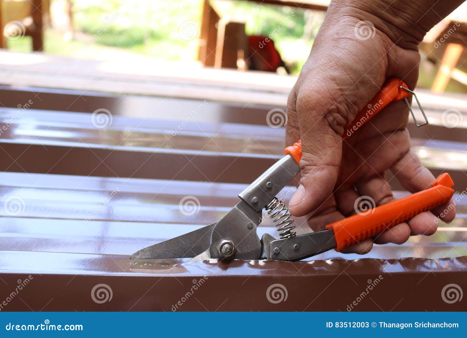 Workers Use Scissors To Cut the Metal Sheet for Roofing. Stock Image