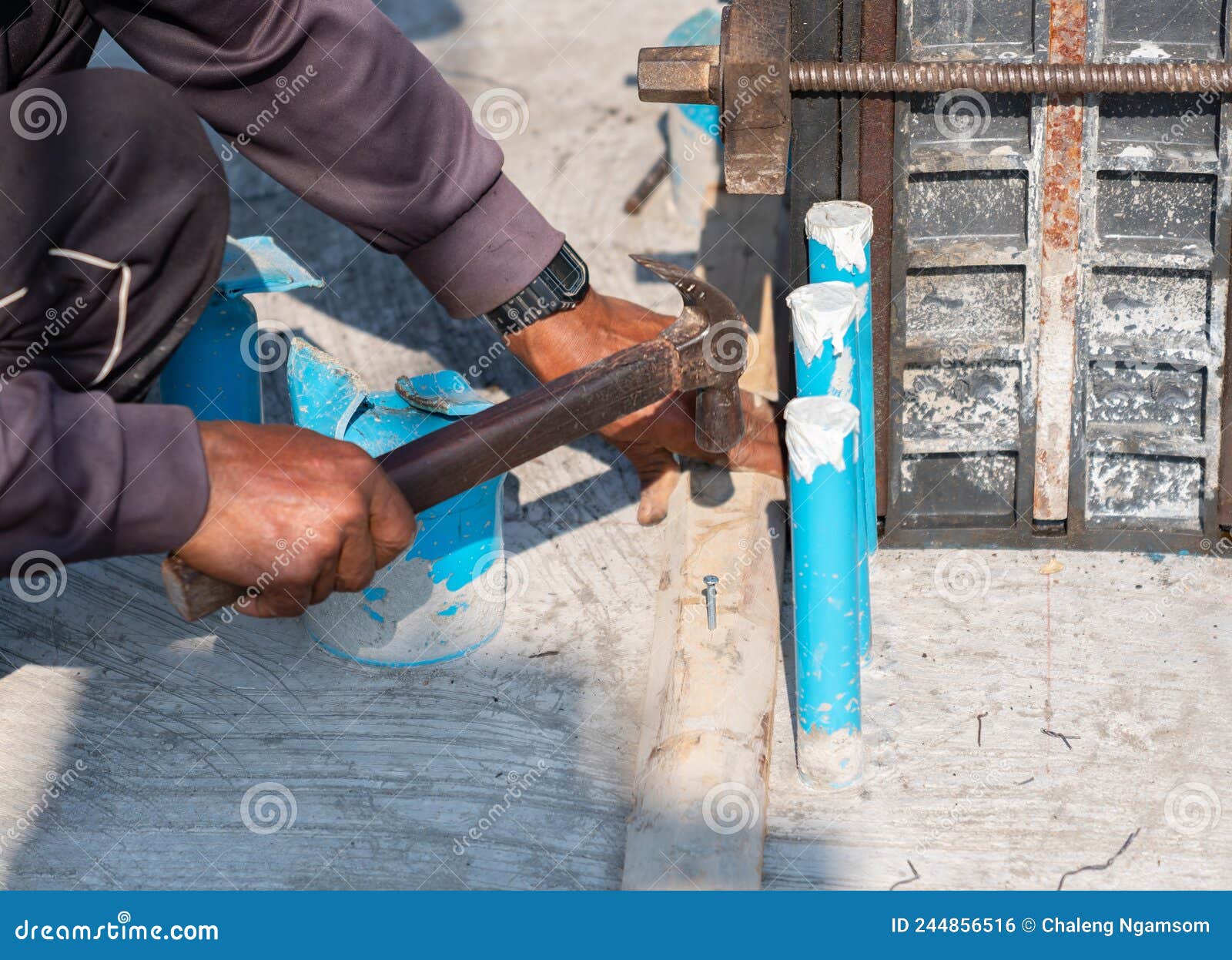 Workers Used Hammers To Hammer Concrete Nails into the Wooden Bars
