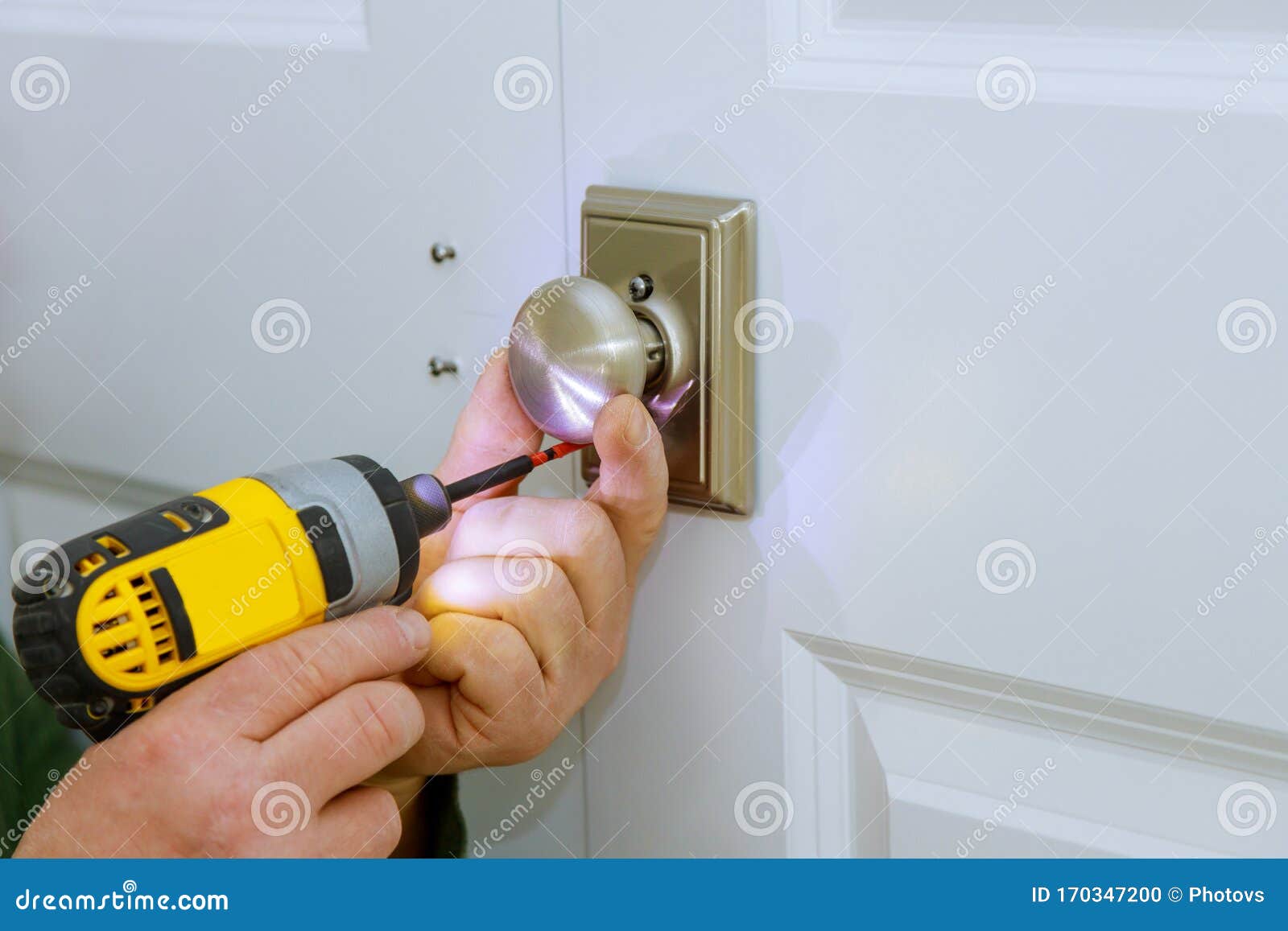 Working As Handyman Install New Door Lock in the Room Stock Photo