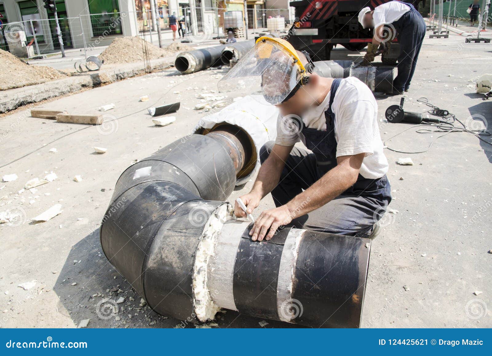 Working with a Crane and Lifting Pipes on the Building Stock Image