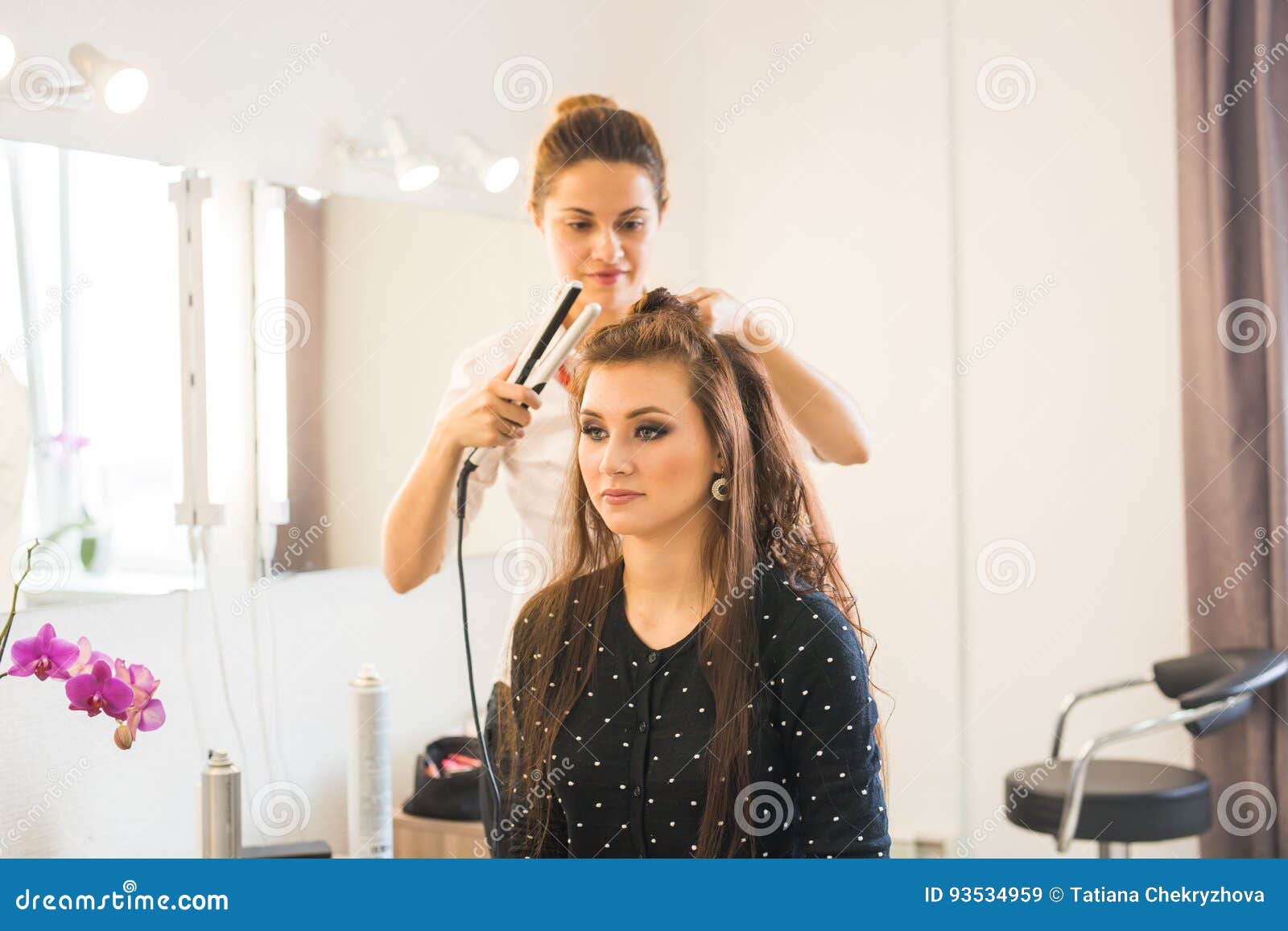 working day inside the beauty salon. hairdresser makes hair styling