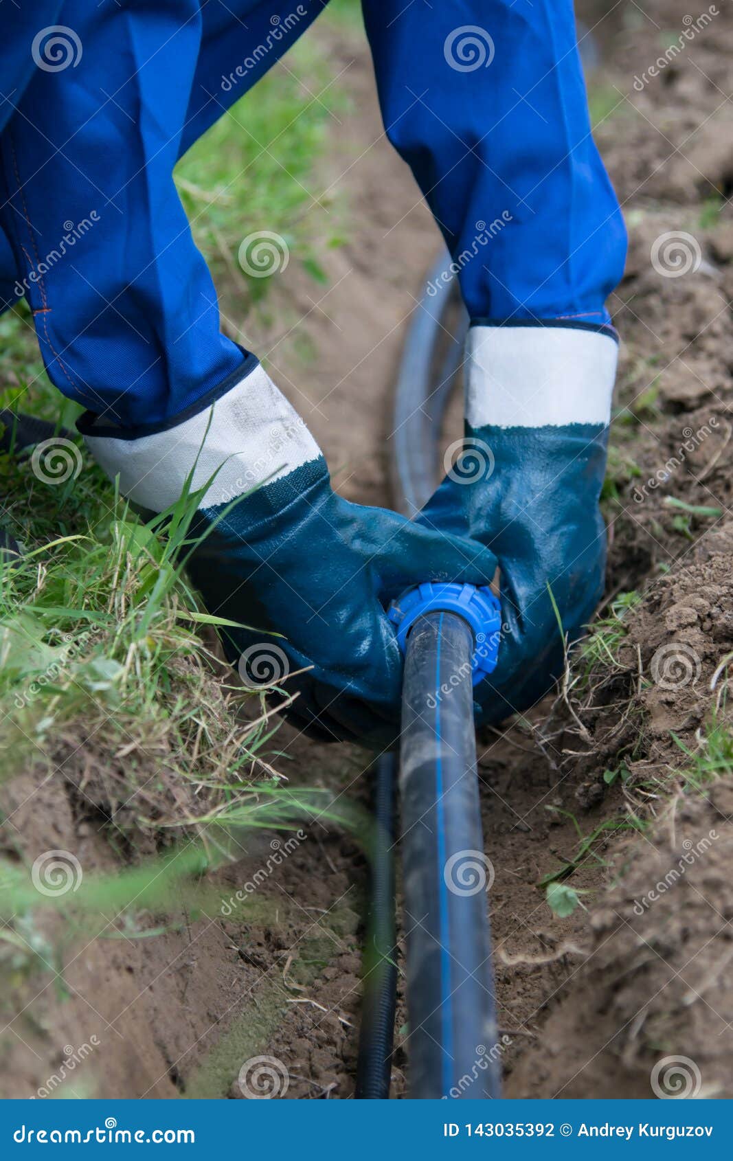 The Working Hands in Gloves, Put the Plastic Pipe in the Dug Trench in