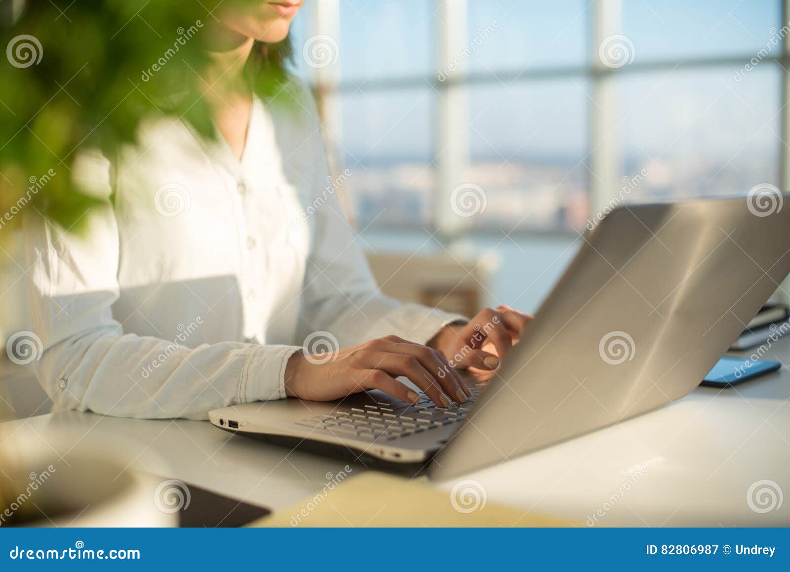 working at home with laptop woman writing a blog. female hands on the keyboard