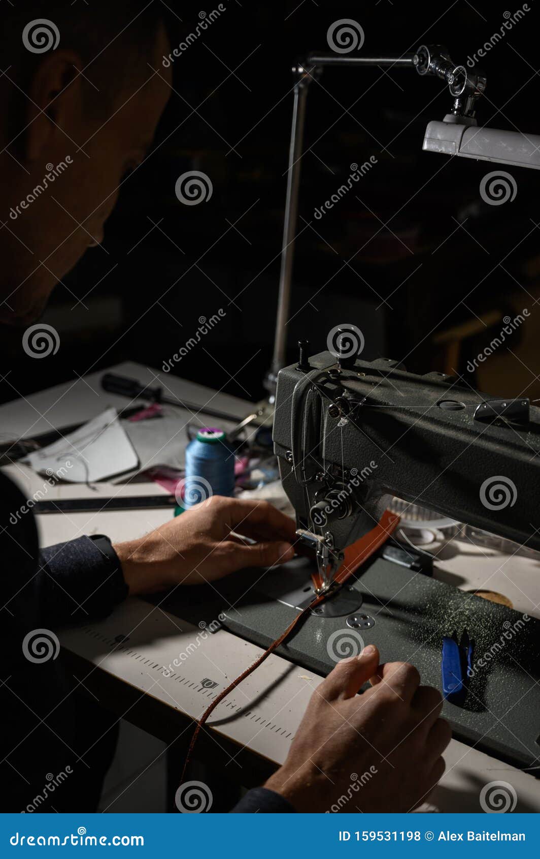 Working Process of Leather Craftsman. Tanner or Skinner Sews Leather on