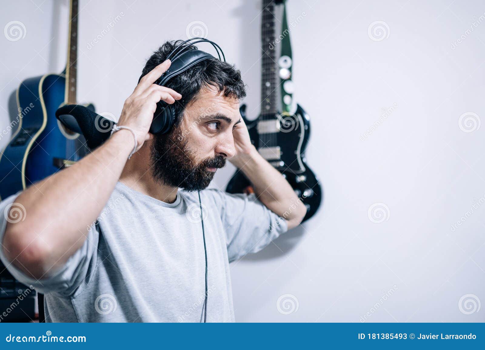 Working Sound Engineer Wearing Headphone in Home Studio Stock Image