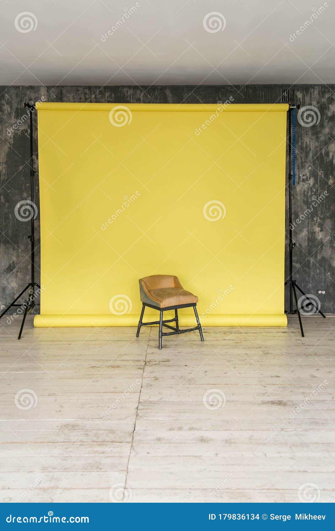 The Working Space of the Photo Studio with a Yellow Paper Background