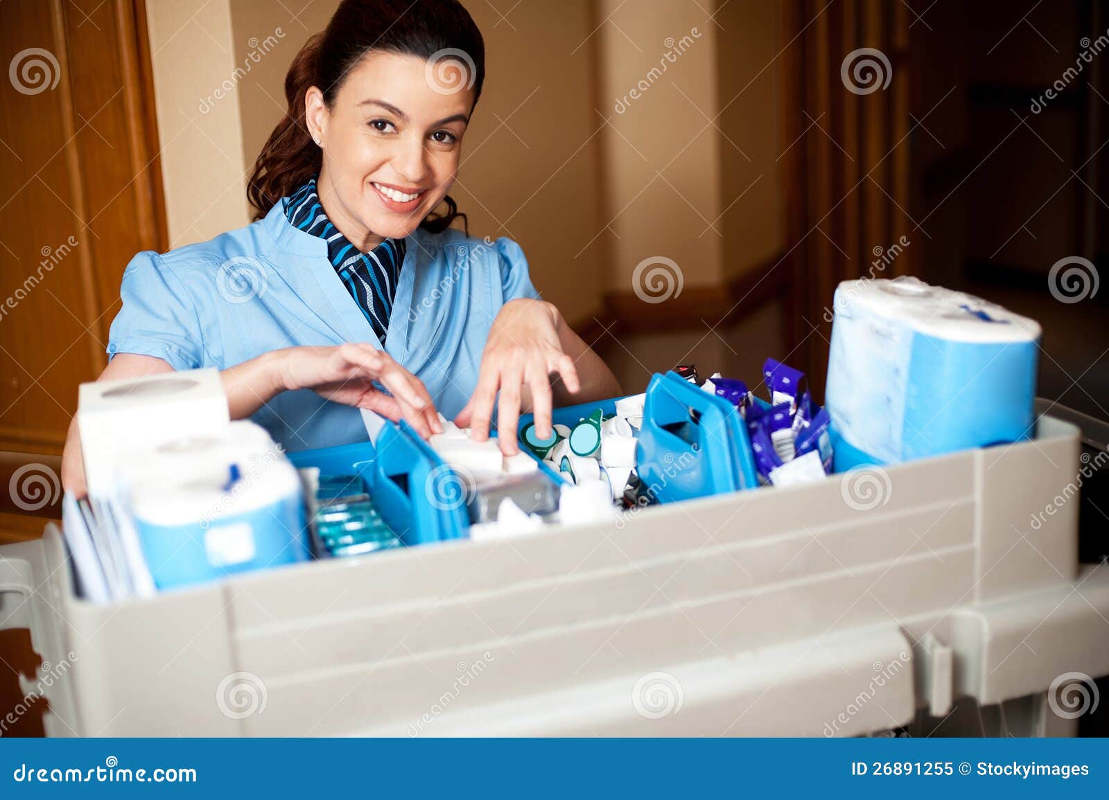 working staff arranging toiletries in a wheel cart