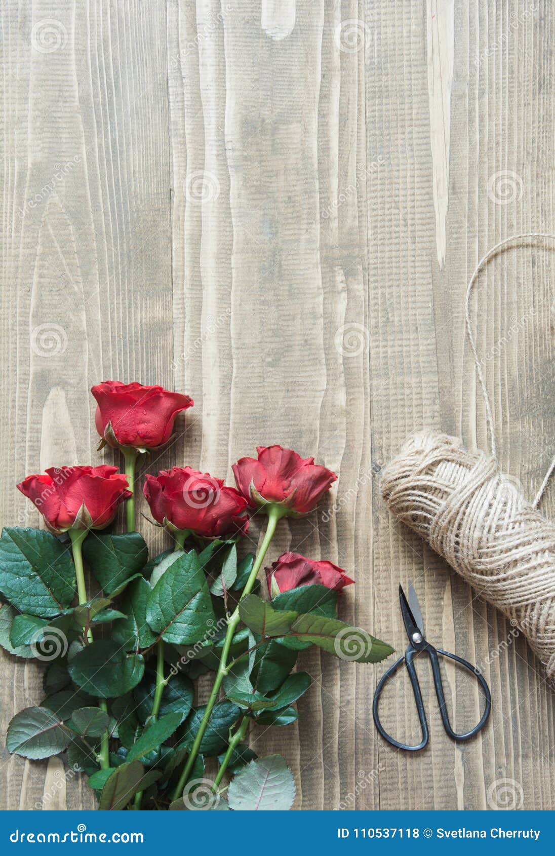 Working Table Florist. Preparation a Bouquet of Red Roses Stock Photo