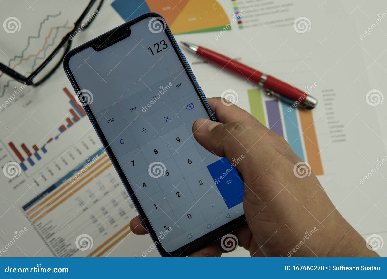 working table with report paper, mobile phone and office stationery.