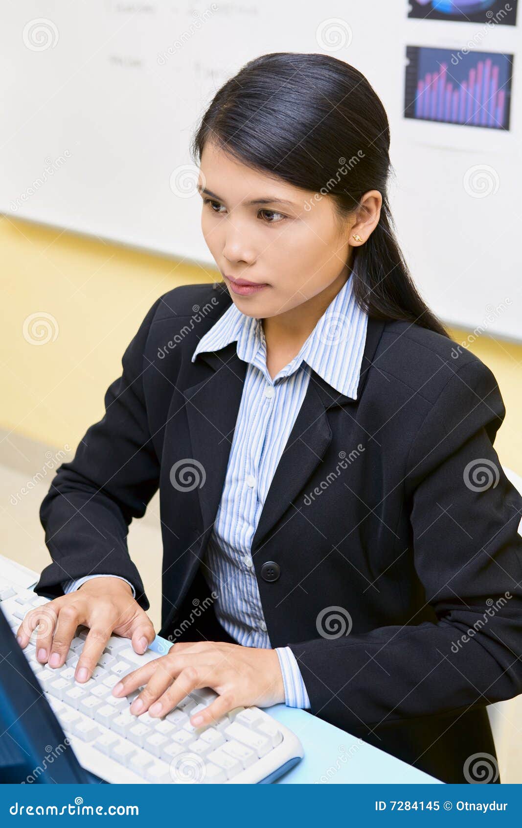 Working time. A woman employee is working in front of her computer in office.