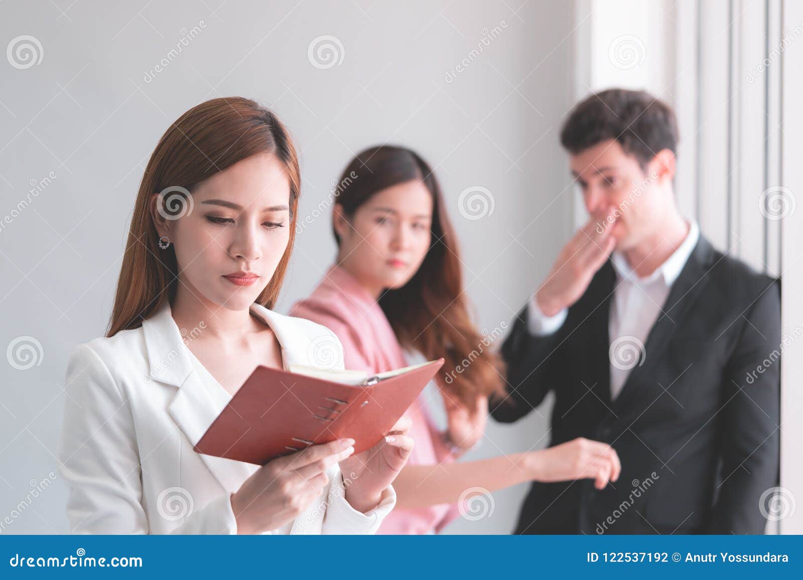 working woman taking gossip from co worker