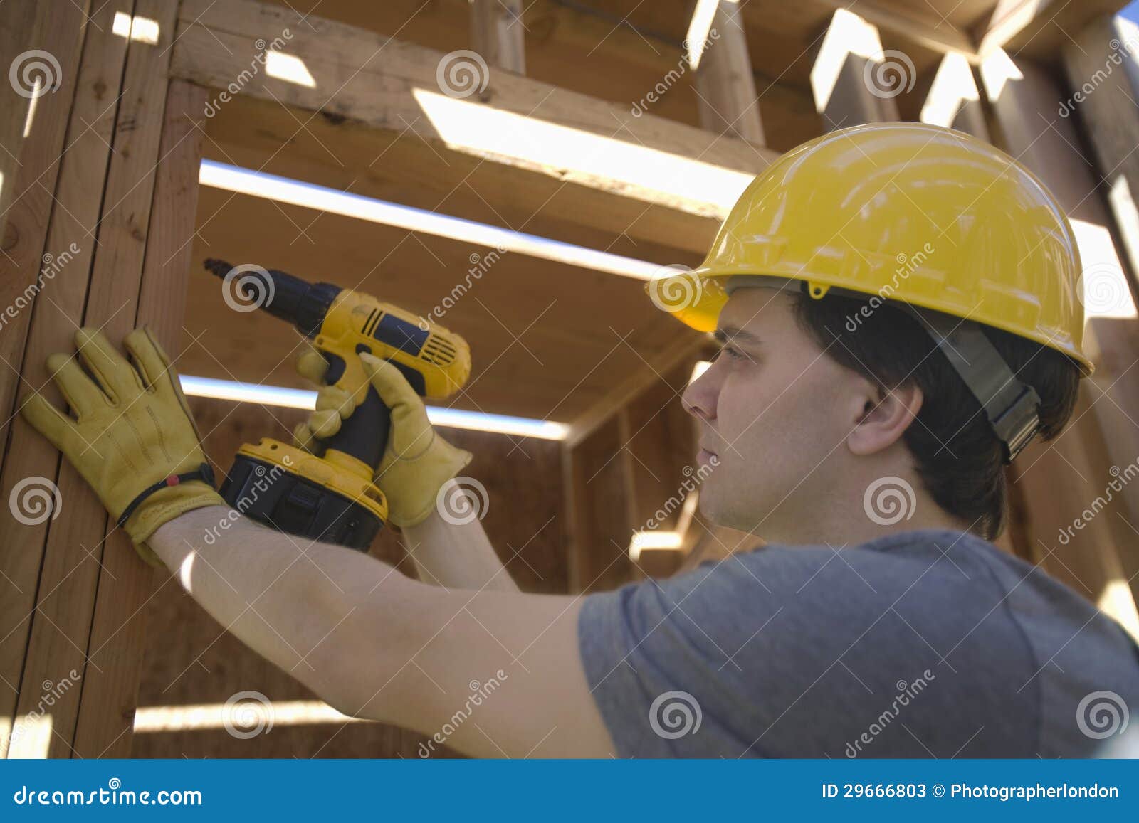 Workman Drilling on a Wooden Beam at Site Stock Image Image of drill