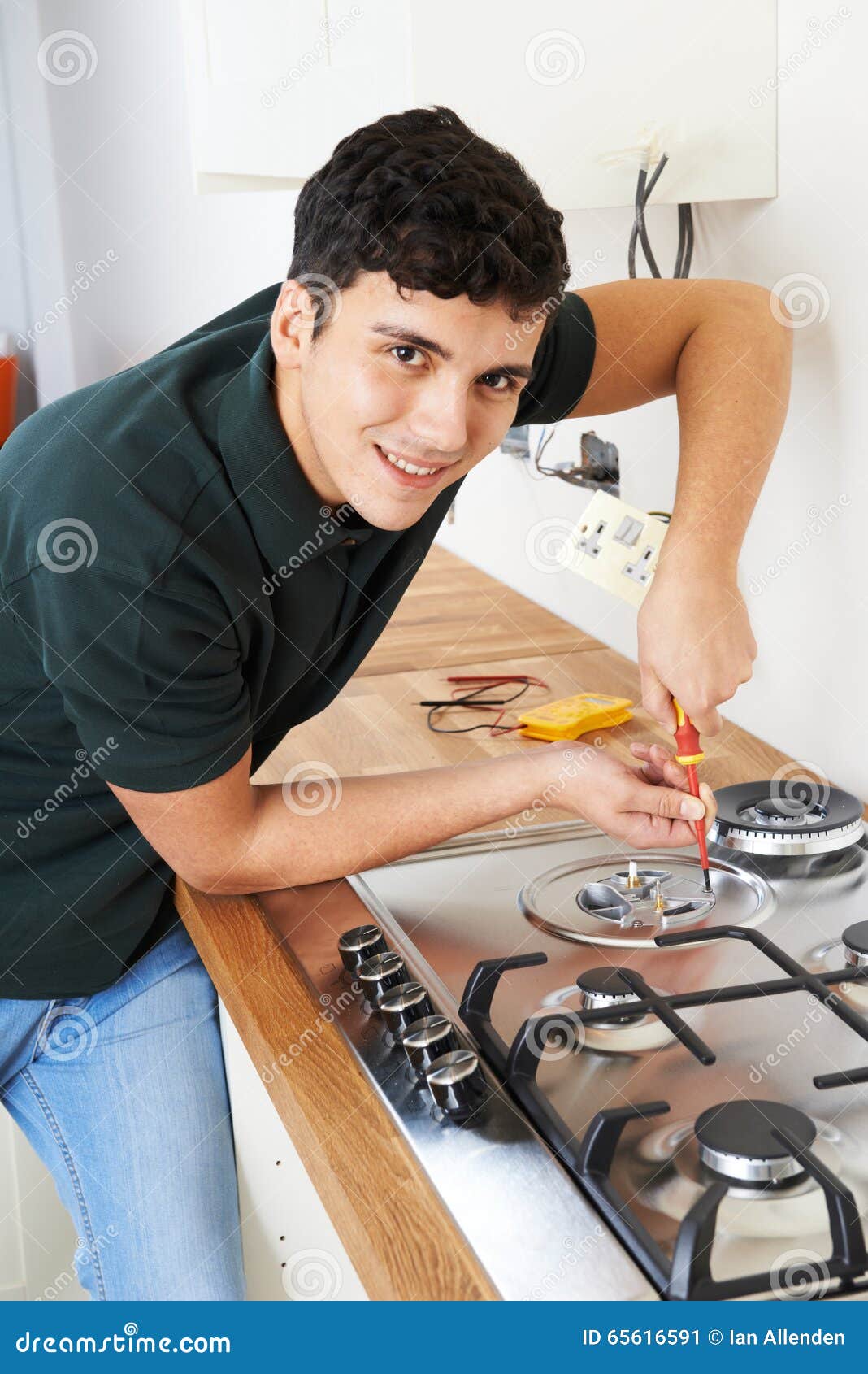 Workman Installing Gas Cooker in New Kitchen Stock Image Image of