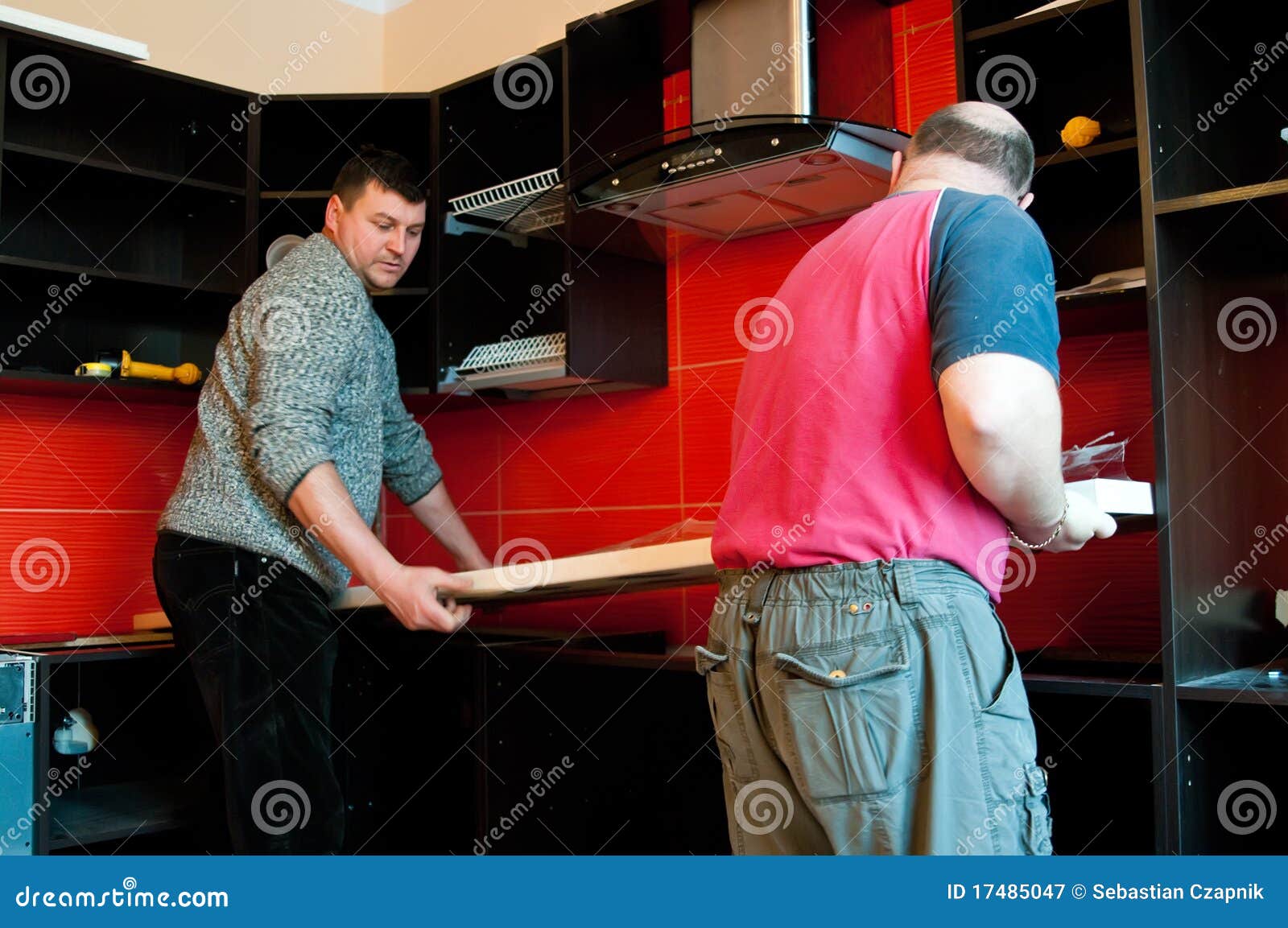 workmen fitting kitchen