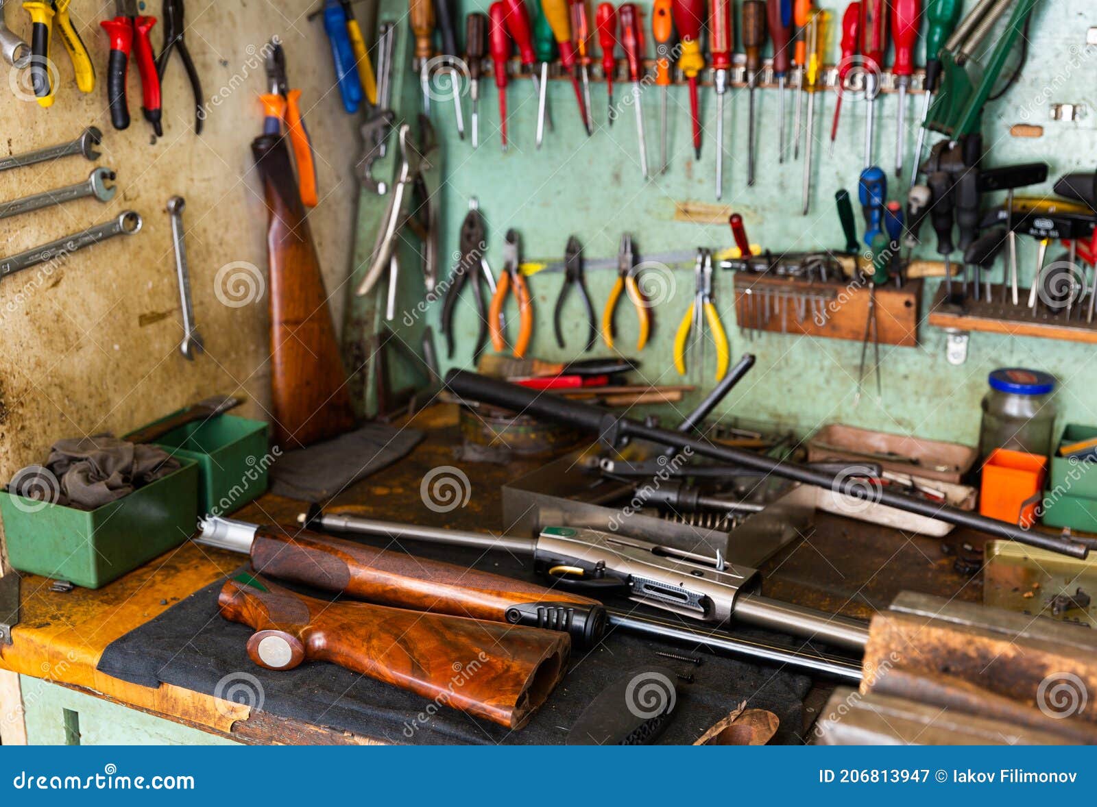 Workplace of Gunsmith in Weapons with Tools and Disassembled