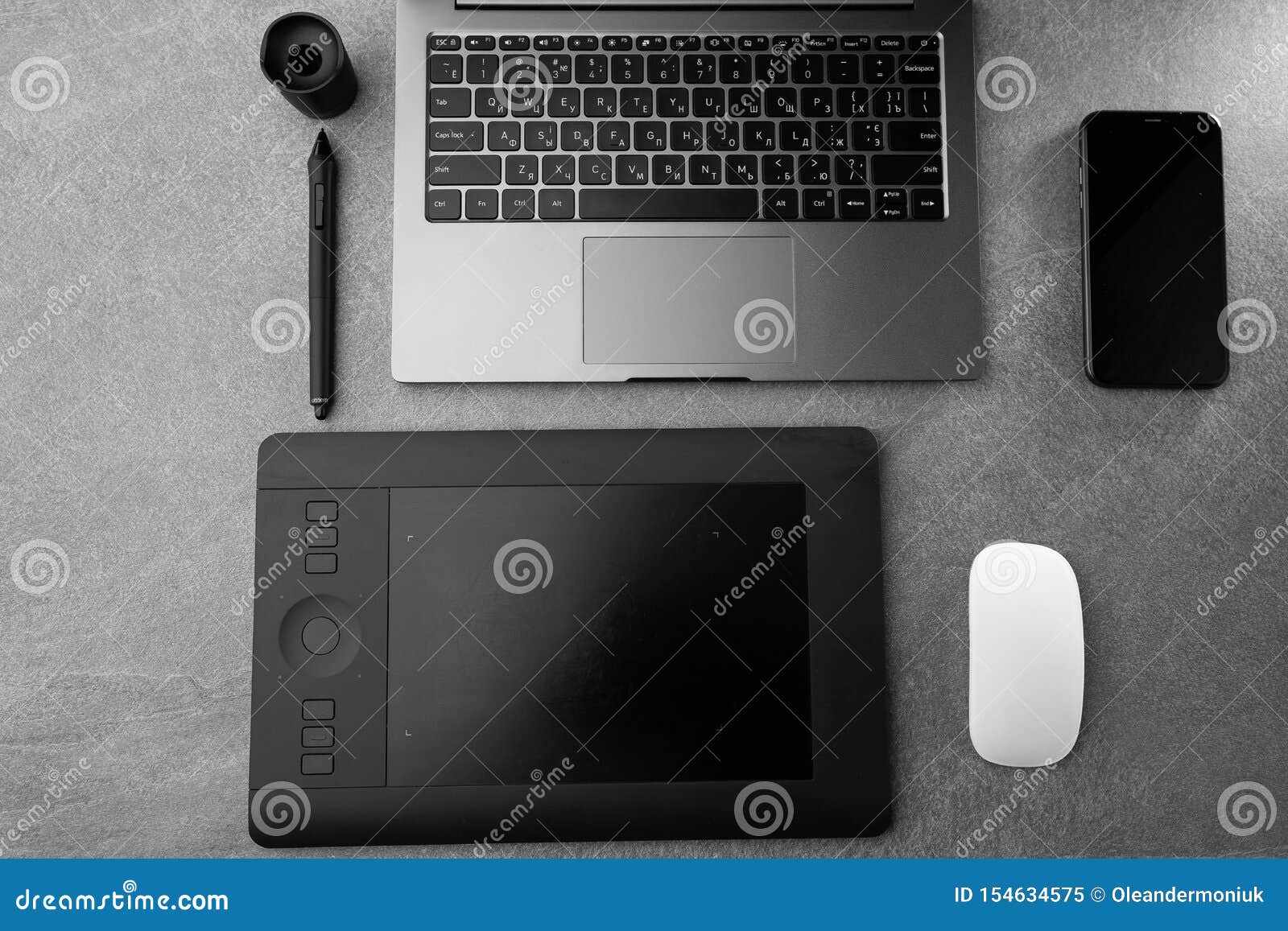Workplace with Open Laptop with Black Screen, Mouse, Graphics Tablet