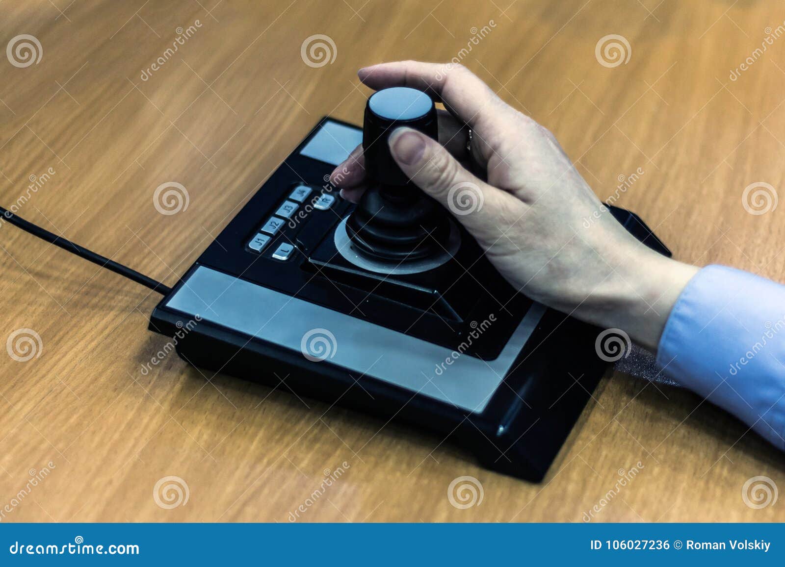 Female Hand Closeup on Joystick Control CCTV. Workplace Operator for
