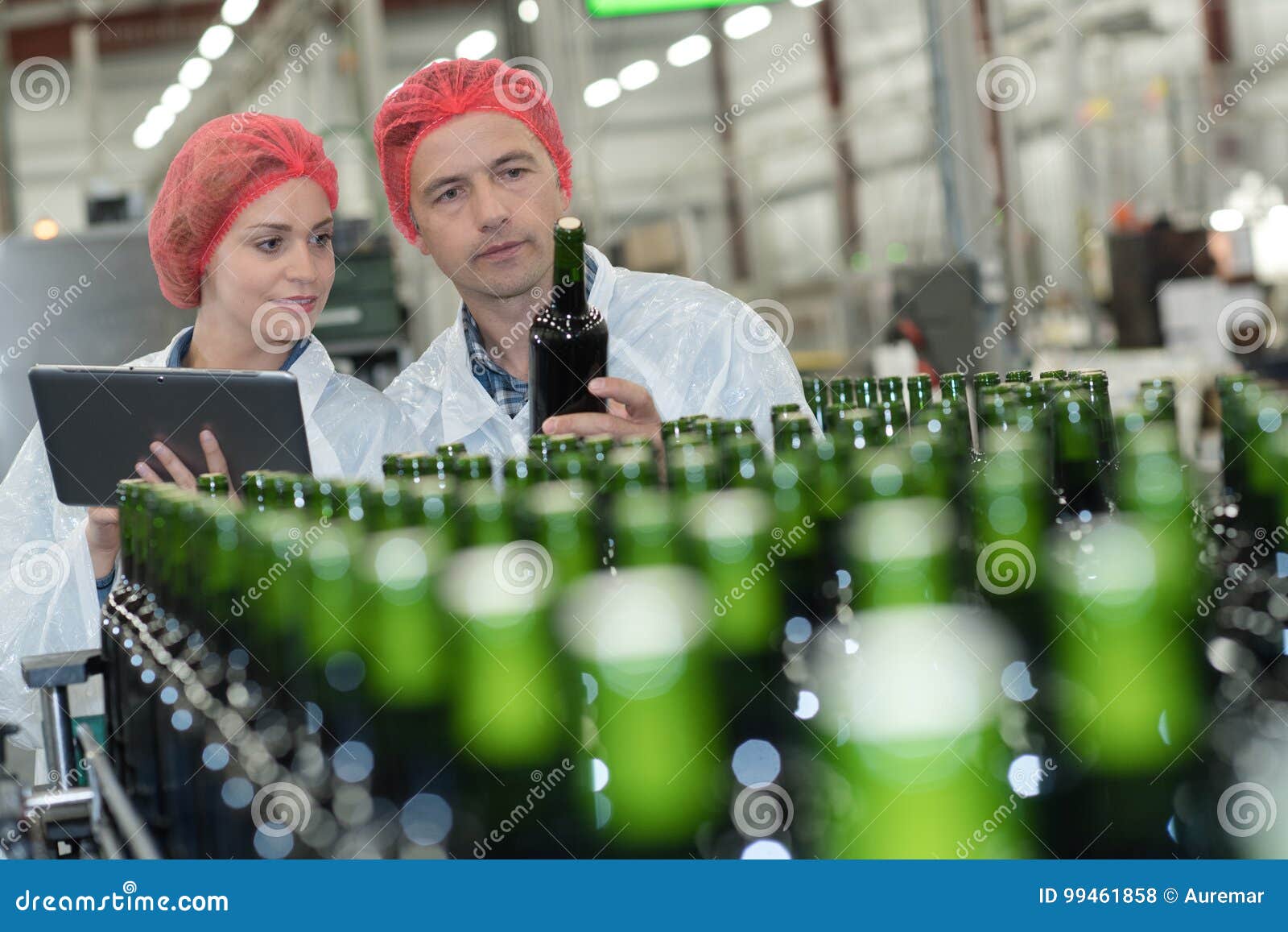 Works Supervising Bottling Line for Processing Stock Photo Image of