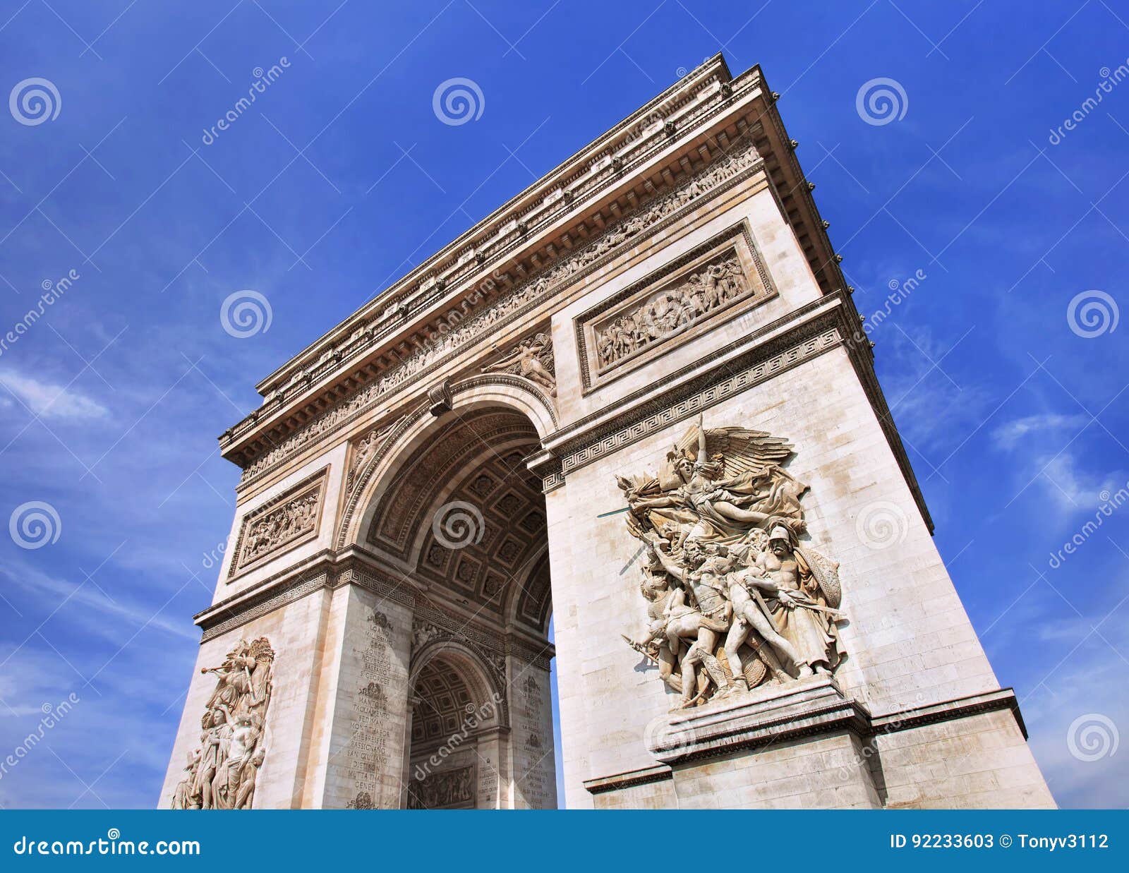 world famous arce de triomphe against a blue sky, paris