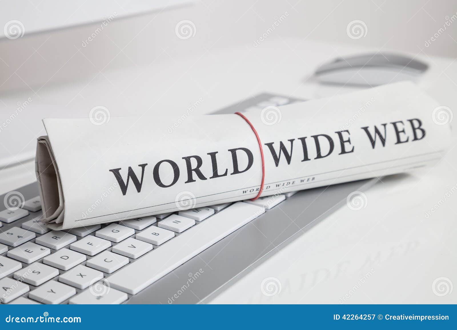 Small typewriter with keyboard in focus over a page of a book. Decoration  item. Concepts of reading, writing, old times, past. Close up. Blurred  background. Stock Photo