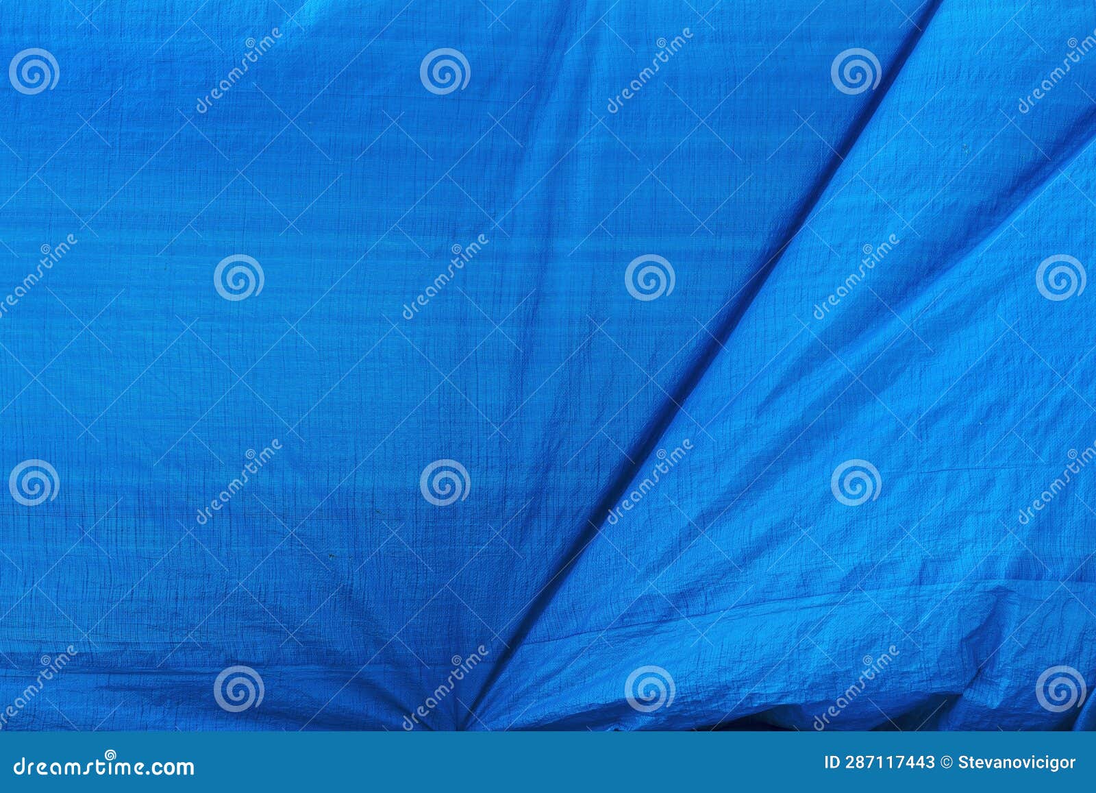 Worn Blue Tarpaulin Material Surface As Background and Industrial